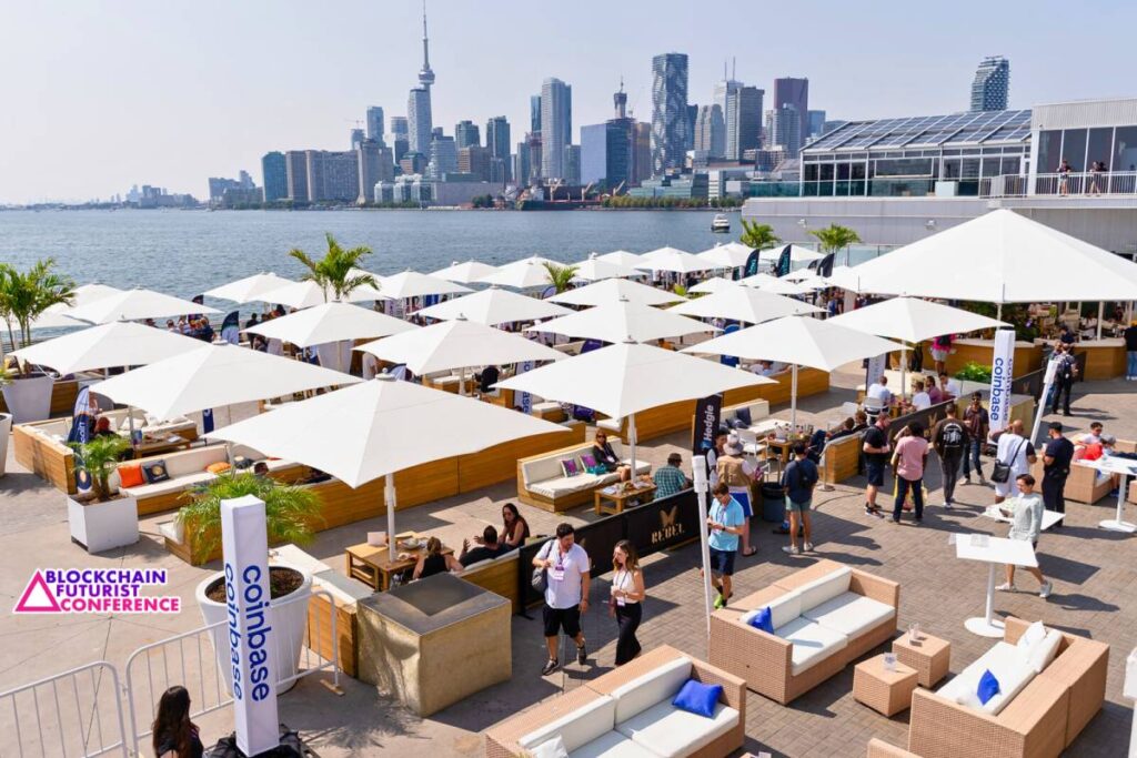 Attendees networking at Blockchain Futurist Conference cabana area with Toronto skyline waterfront venue.